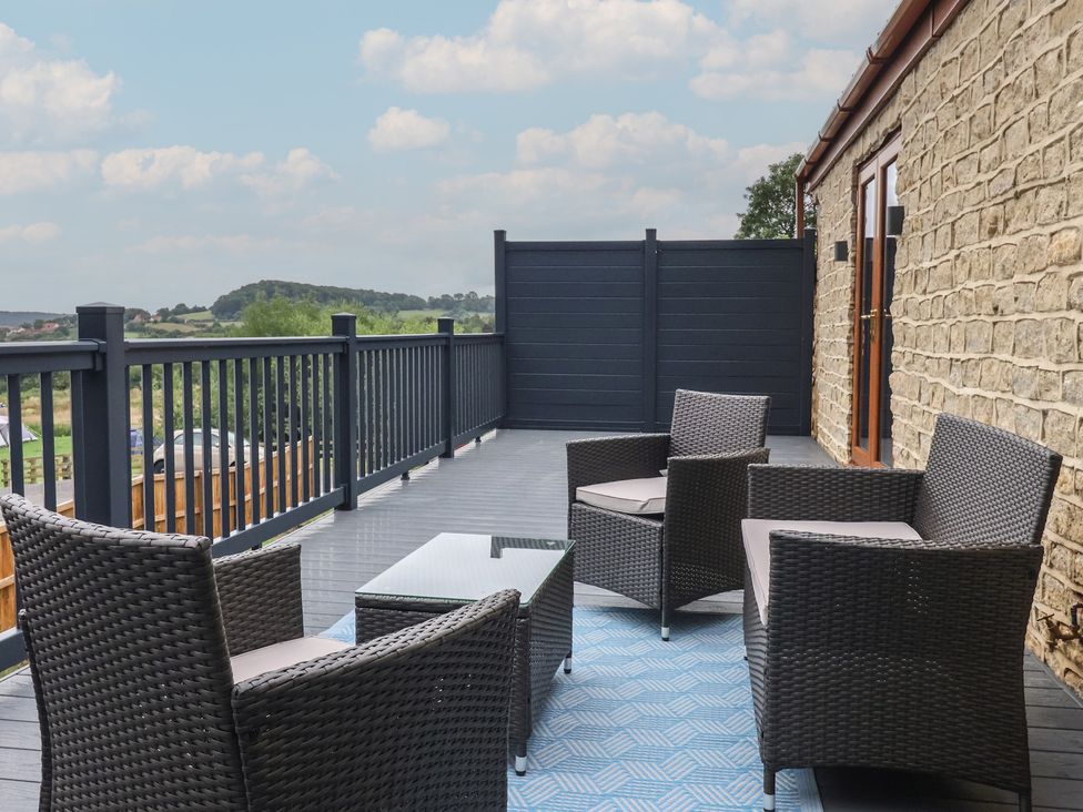An outdoor area with chairs and table at Castle View in Scarborough