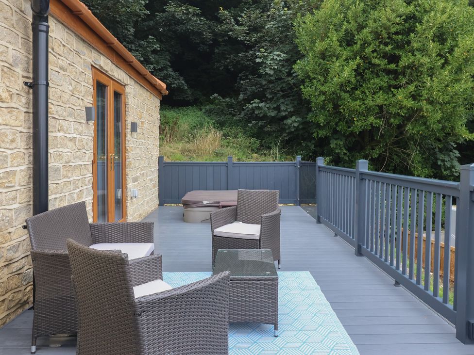 An outdoor space with chairs and a table near a hot tub at Castle View in Scarborough