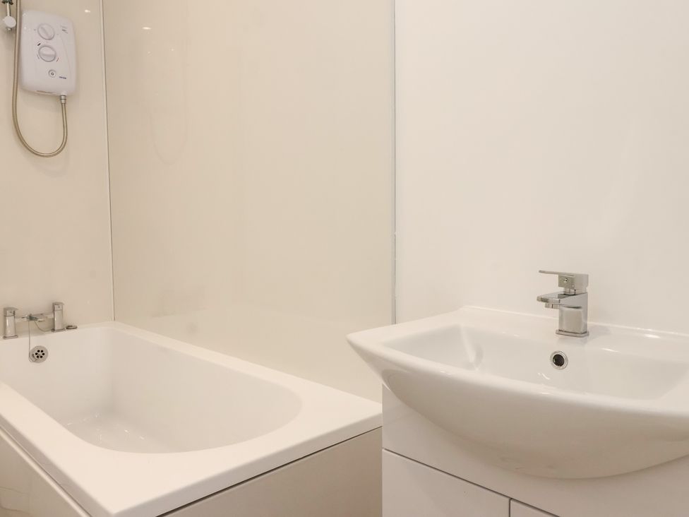 A bathroom featuring a bathtub and sink at Castle View in Scarborough