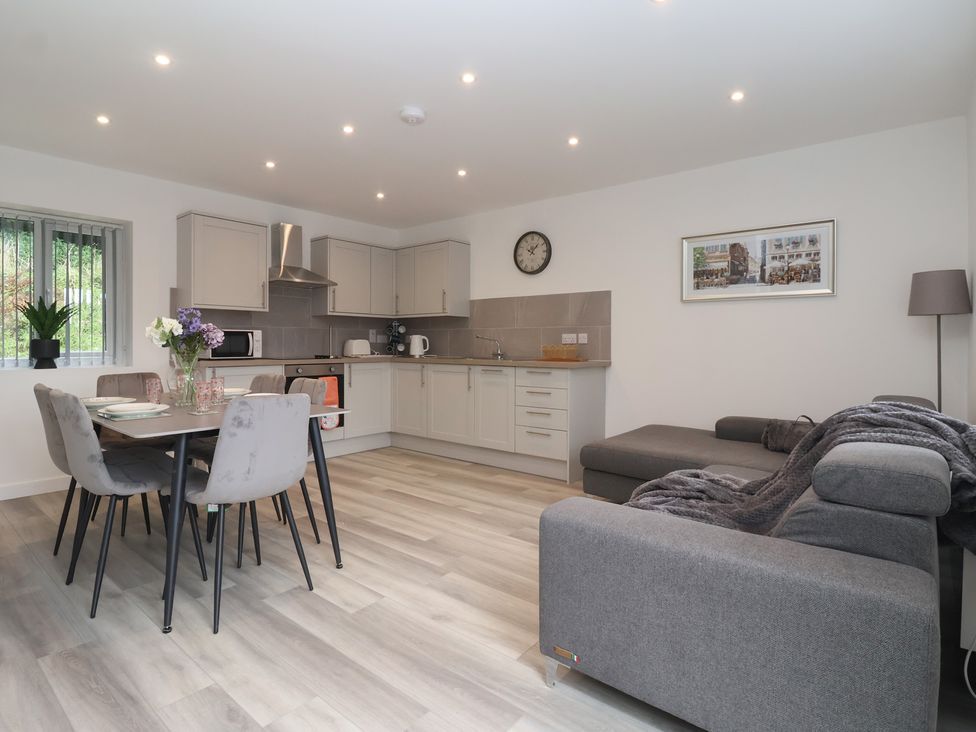 A kitchen and dining area with furniture at Woodside in Scarborough