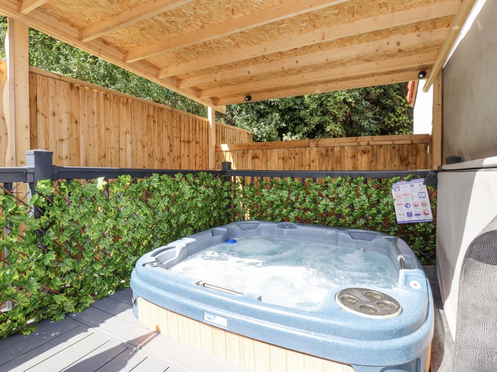 An outdoor hot tub surrounded by wooden fencing at Woodside in Scarborough