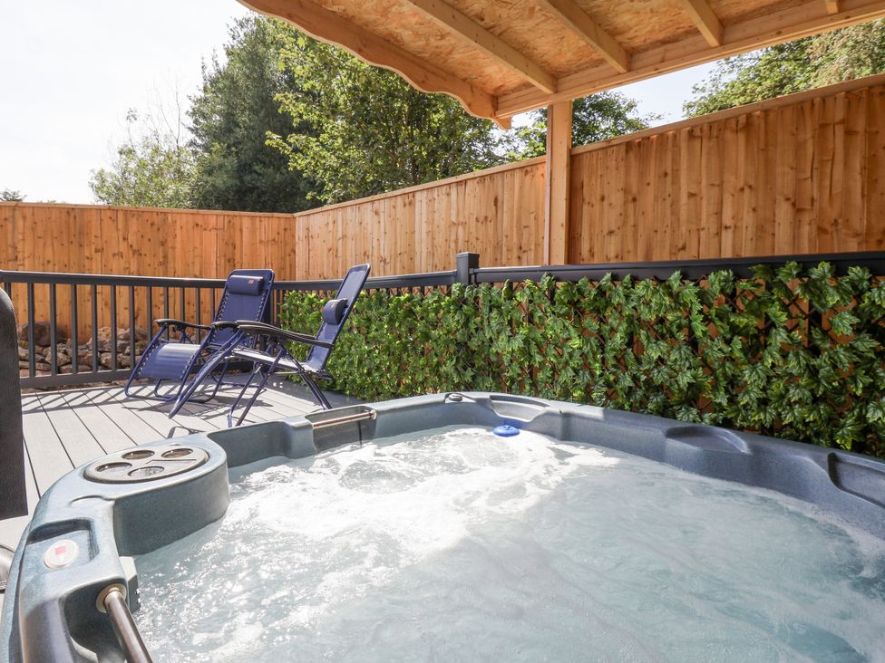 A hot tub and lounge chairs in an outdoor area at Woodside in Scarborough