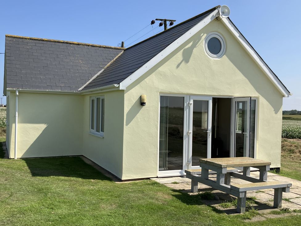 A house with a patio and table at Seadrift near Stalham