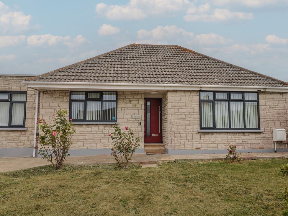 A house with a red door and garden at 7 Cedar Drive Preston