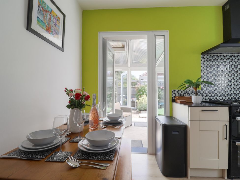 A kitchen with dining table set for a meal at 7 Cedar Drive in Preston