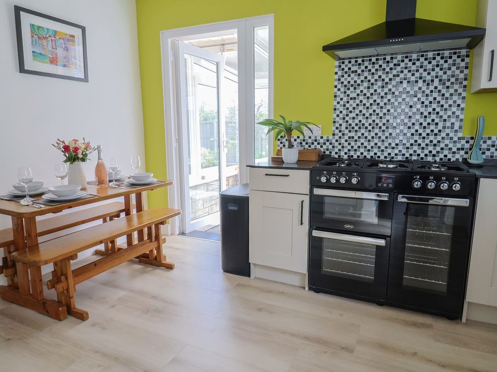 A kitchen with a dining table and oven at 7 Cedar Drive Preston