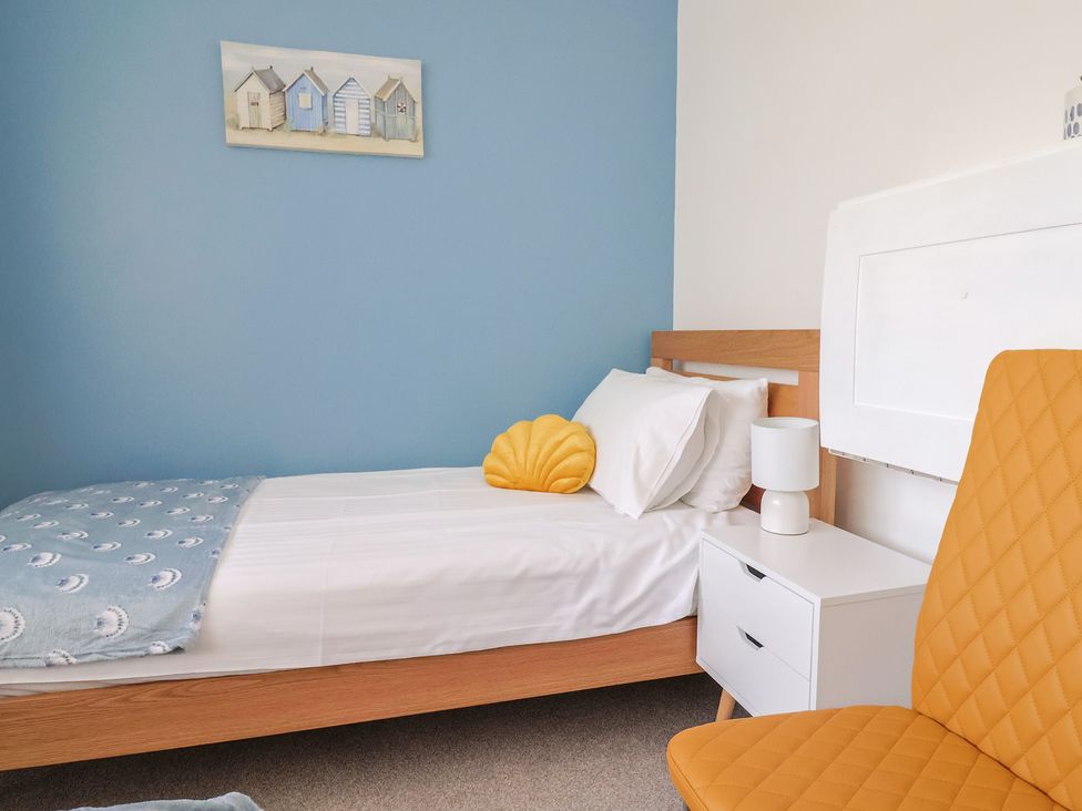 A bedroom with a bed and a lamp at 7 Cedar Drive, Preston