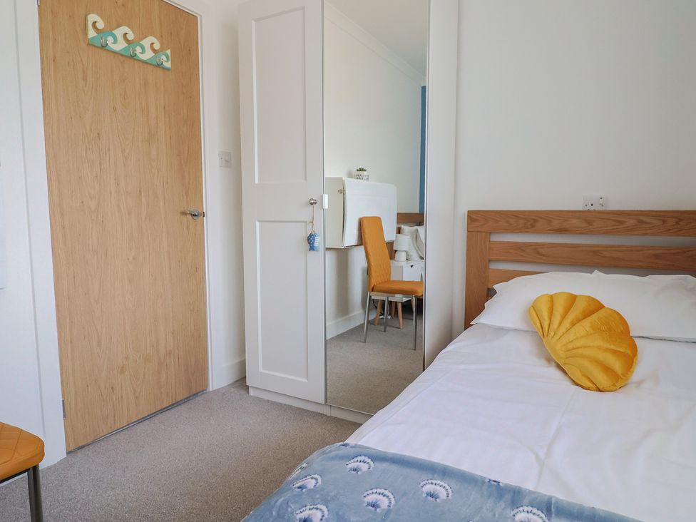 A bedroom with a bed and a chair at 7 Cedar Drive Preston