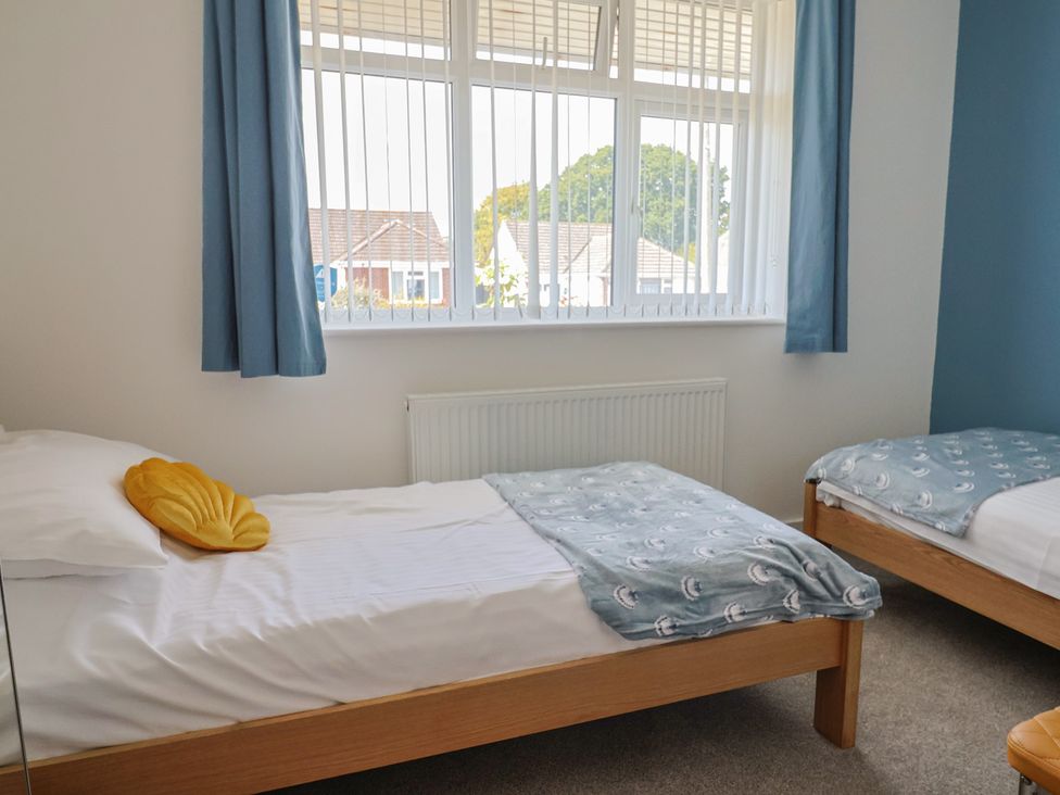 A bedroom with two beds and a window at 7 Cedar Drive Preston