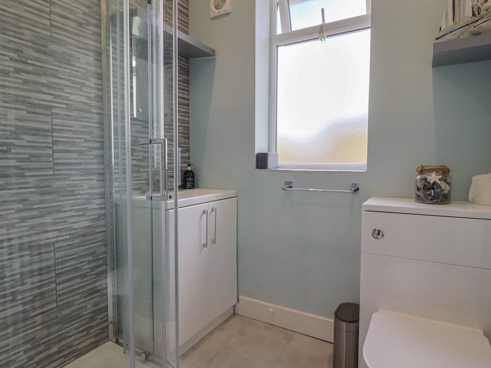 A bathroom with a shower, sink, and toilet at 7 Cedar Drive Preston