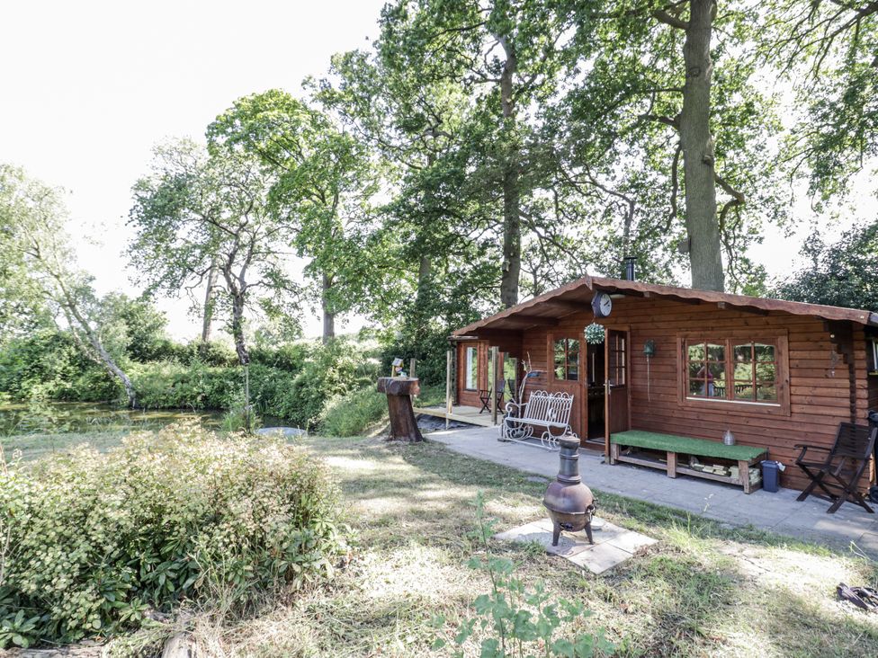 A cabin with seating area in the garden at The Lodge