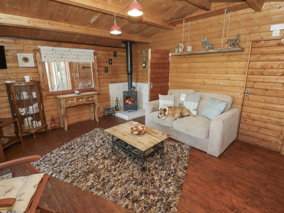 A living room with a sofa and fireplace at The Lodge 