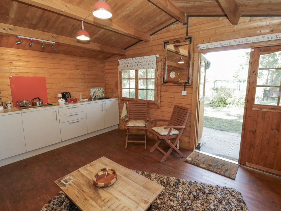 A kitchen with a table and chairs at The Lodge