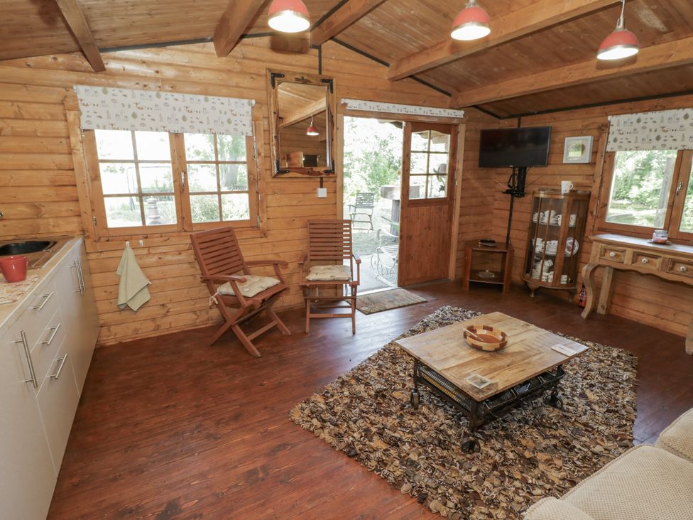 A living room with a table and chairs at The Lodge in 
