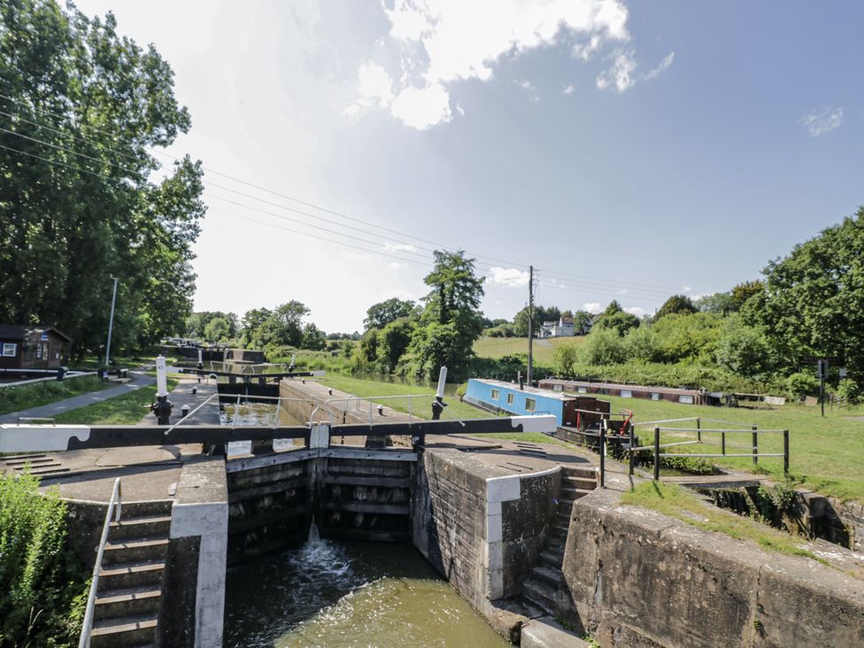 A waterway with lock gates and boats alongside a path at The Lodge in 
