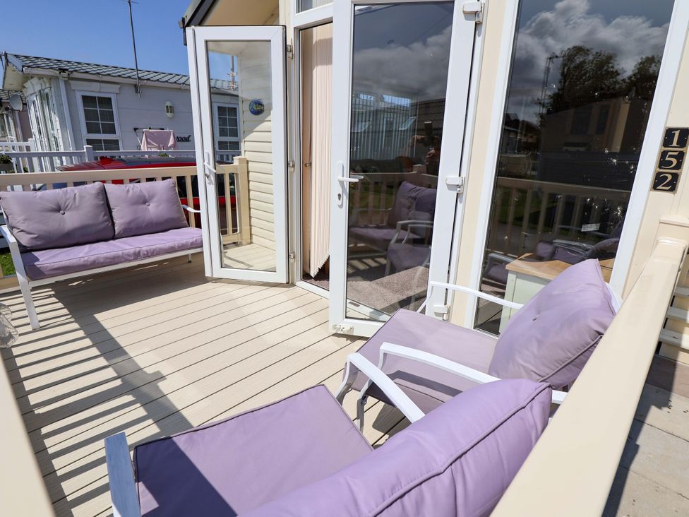 An outdoor seating area with purple furniture at 152 Central Park in Prestatyn