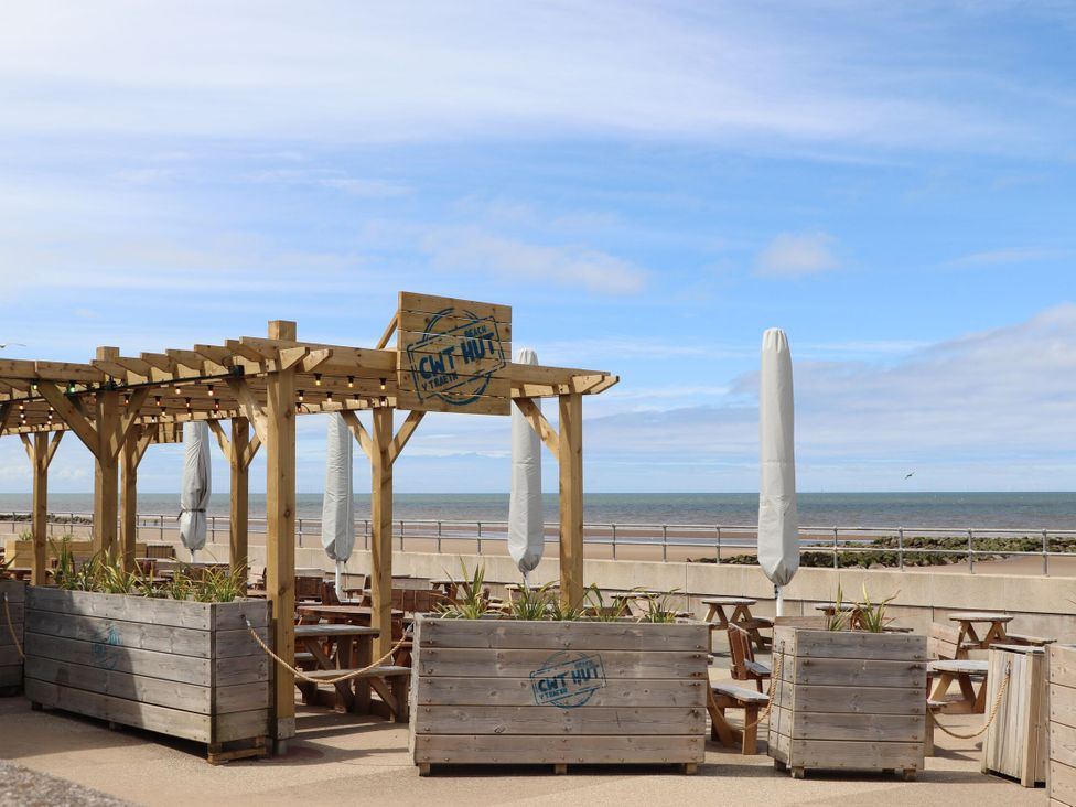 An outdoor seating area with wooden structures at 152 Central Park in Prestatyn