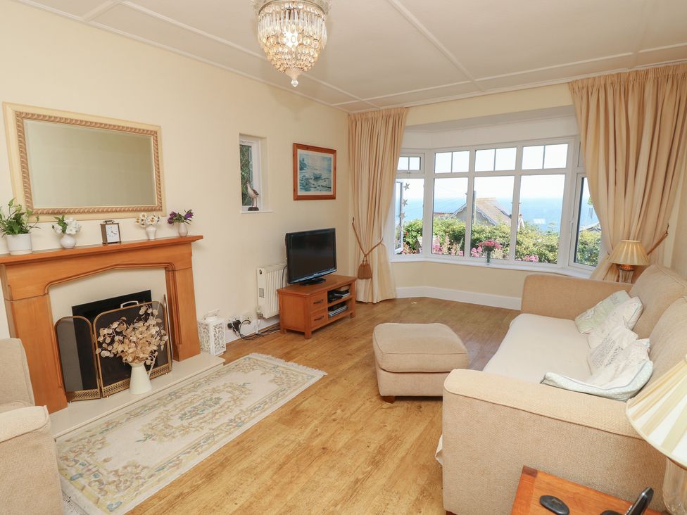 A living room with a sofa and television at Poppy Cottage in Ventnor