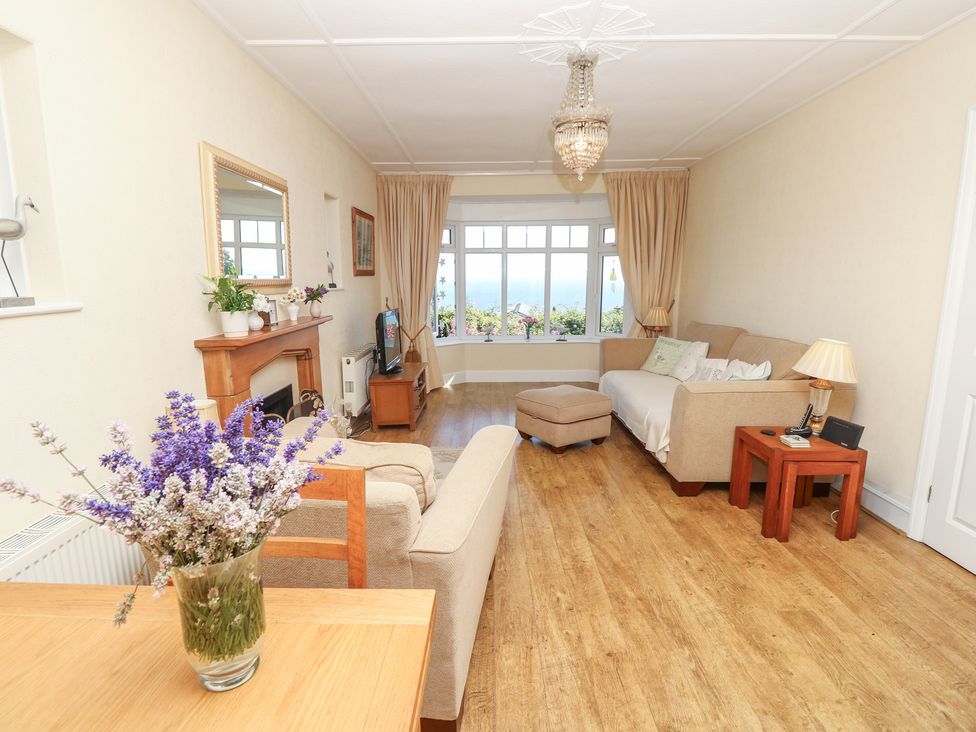 A living room with a sofa and coffee table at Poppy Cottage Ventnor