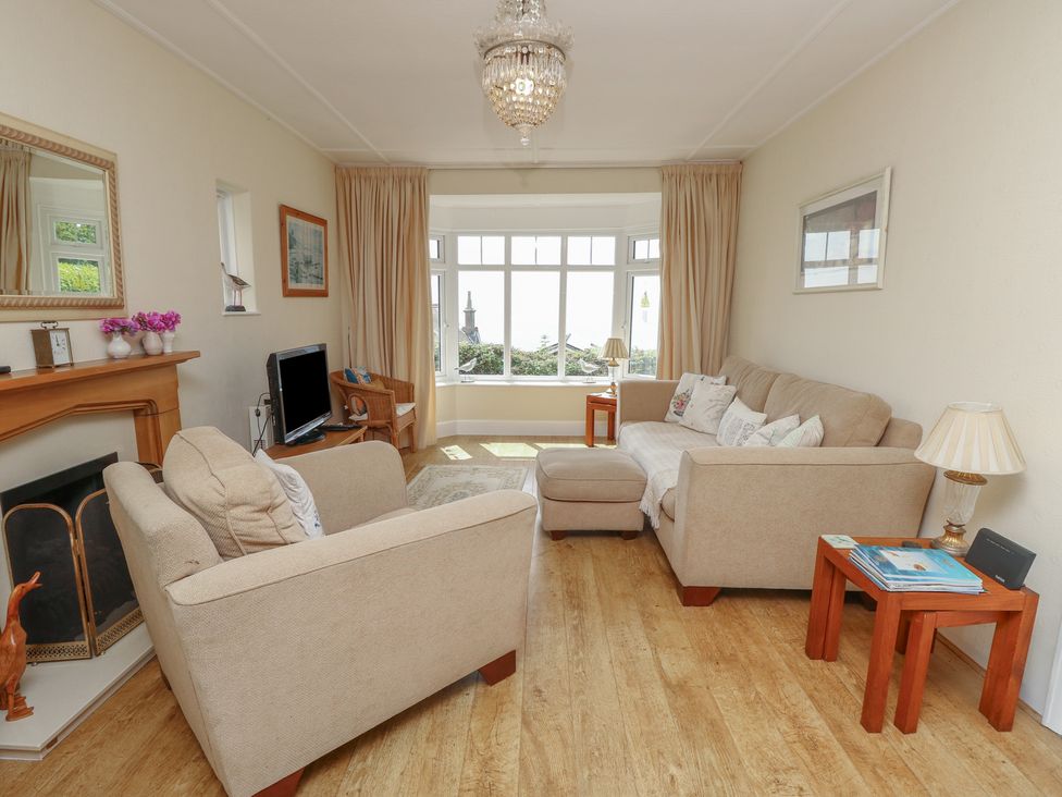 A living room with a sofa and television at Poppy Cottage in Ventnor