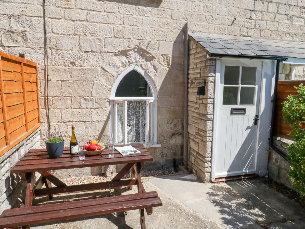 An outdoor area with a table and chairs at Driftwood in Weymouth