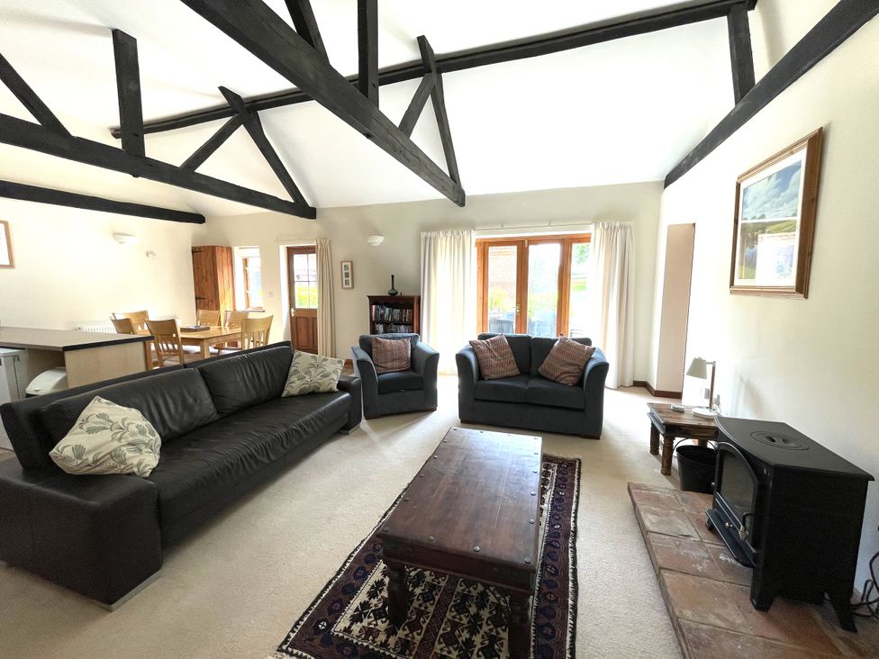 A living room with a sofa and chairs at Beechwood in Wood Norton near Foulsham
