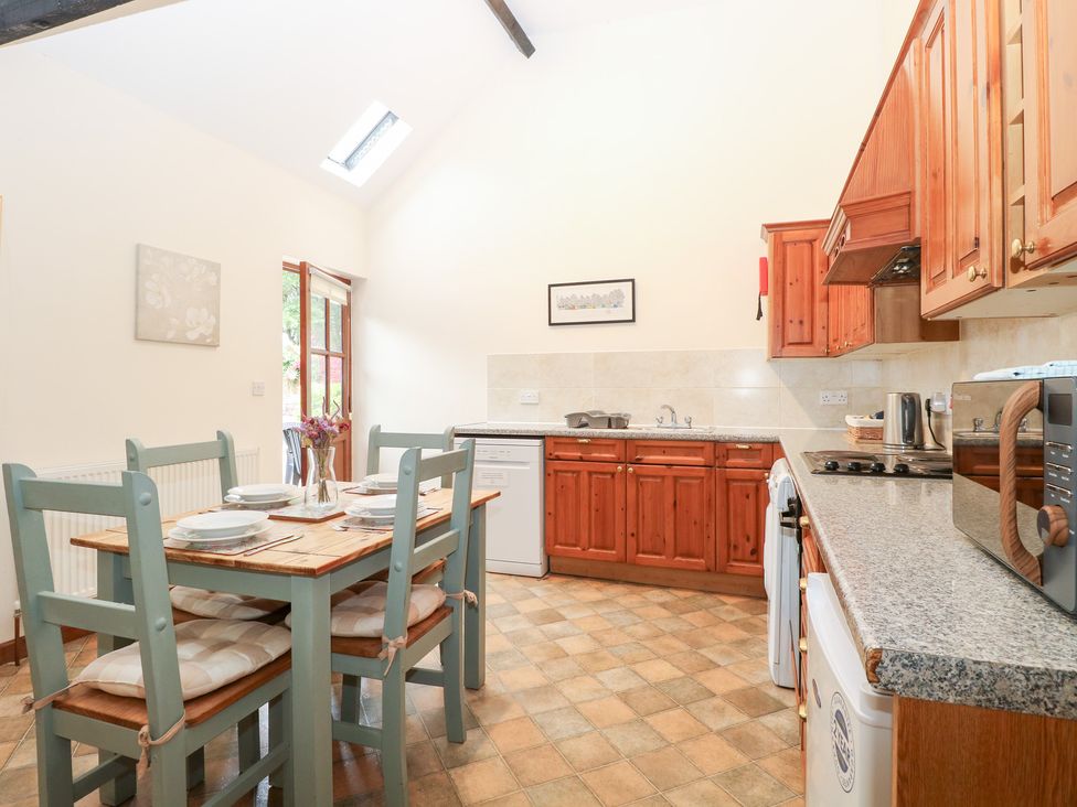 A kitchen with a table and chairs at Willow in Wood Norton near Foulsham