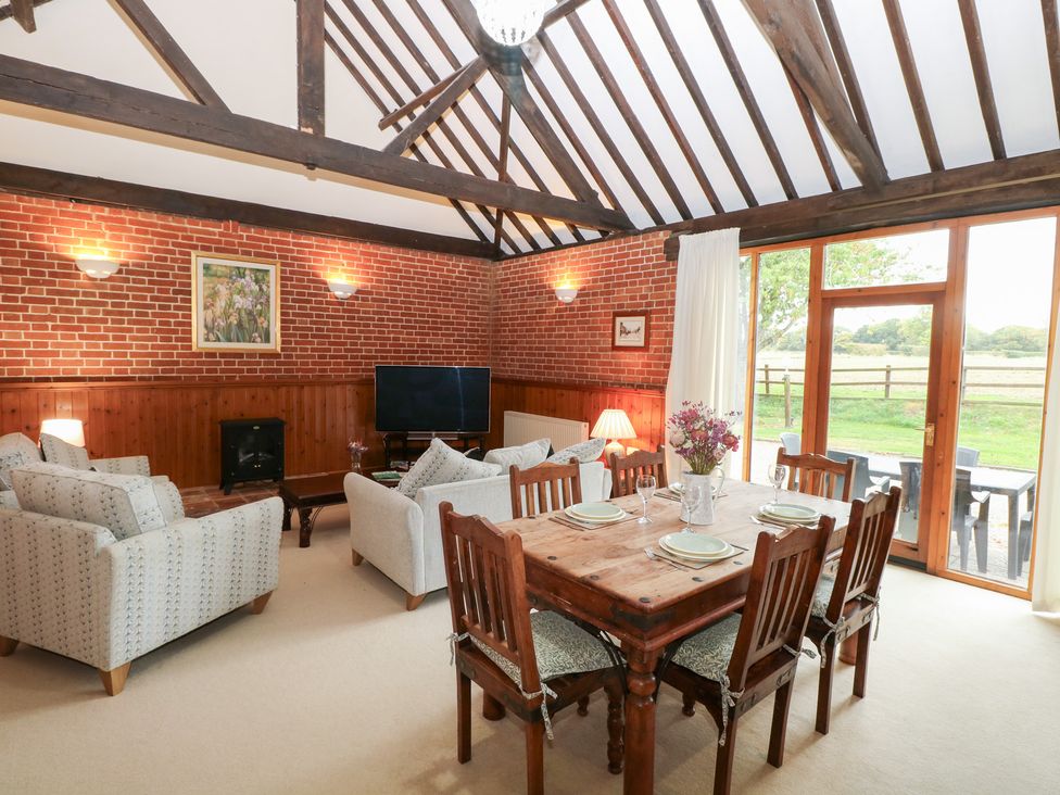 A living room with a dining area at Pear Tree in Wood Norton