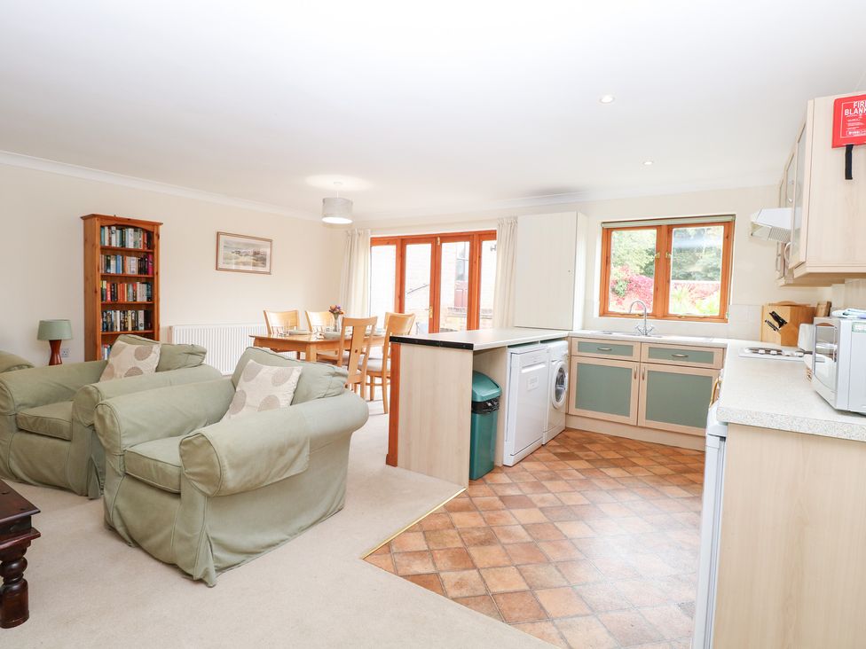 A living room and kitchen with seating and dining area at Sycamore in Wood Norton near Foulsham