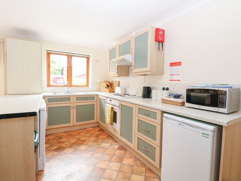 A kitchen with appliances and cabinets at Sycamore in Wood Norton near Foulsham