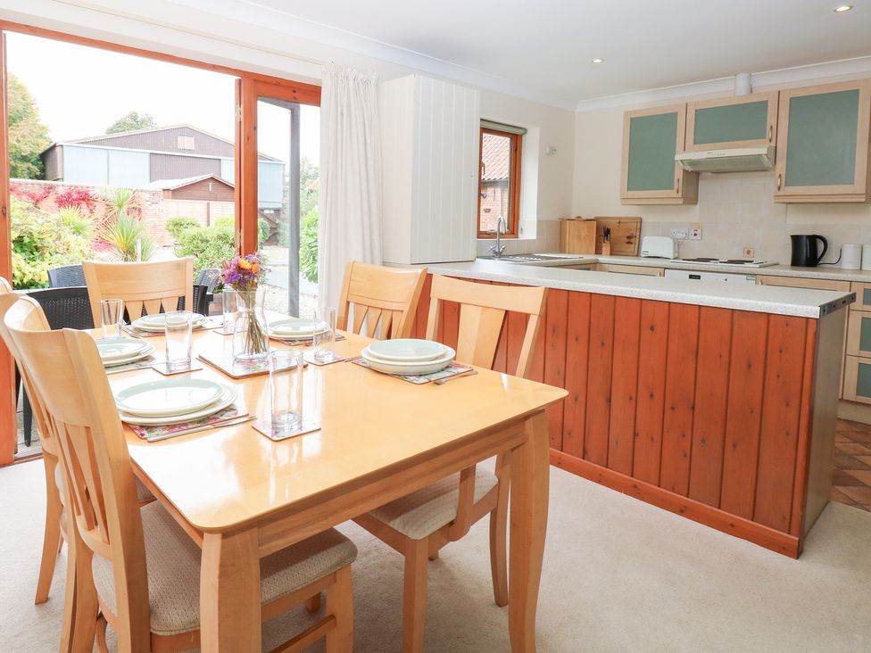 A dining area with table and chairs at Sycamore in Wood Norton near Foulsham