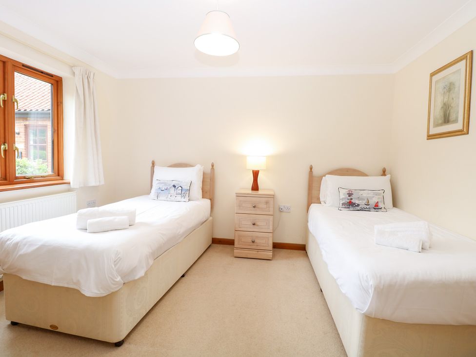 A bedroom with two single beds in Sycamore Wood Norton near Foulsham