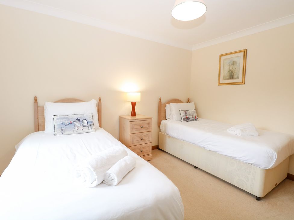 A bedroom with two single beds and a nightstand at Sycamore in Wood Norton near Foulsham