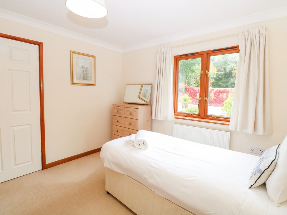 A bedroom with a bed and window at Sycamore in Wood Norton near Foulsham