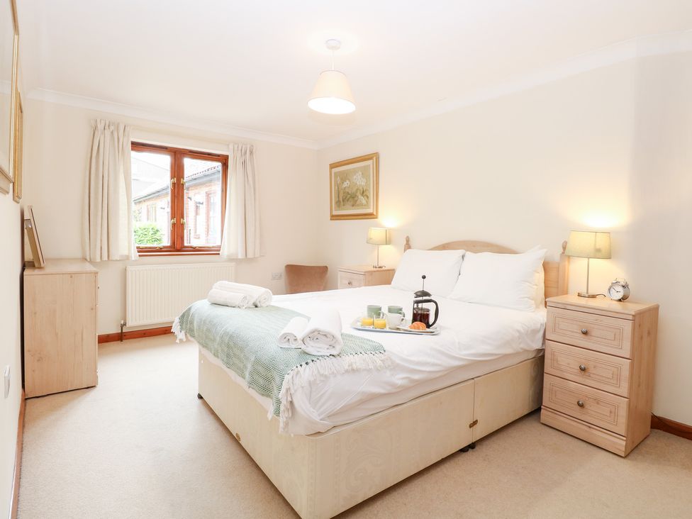 A bedroom with a bed and a tea tray at Sycamore Wood Norton near Foulsham