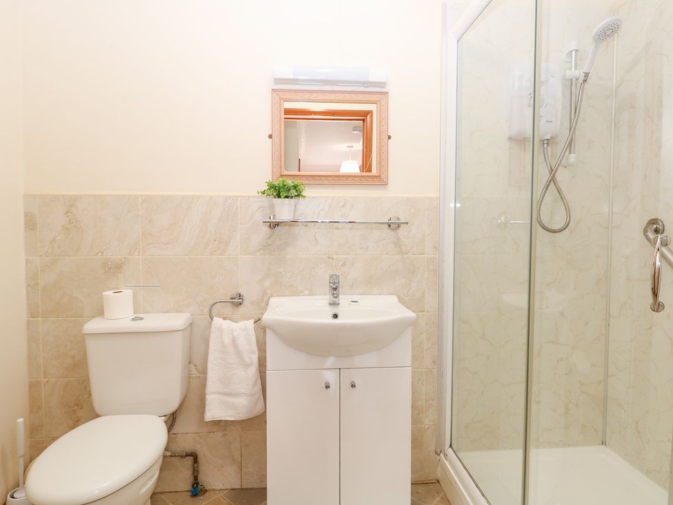 A bathroom with a shower and sink at Sycamore Wood Norton near Foulsham