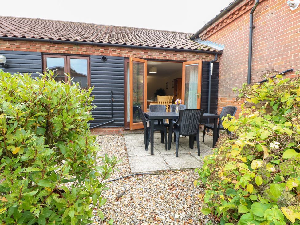 An outdoor area with a table and chairs at Sycamore in Wood Norton near Foulsham