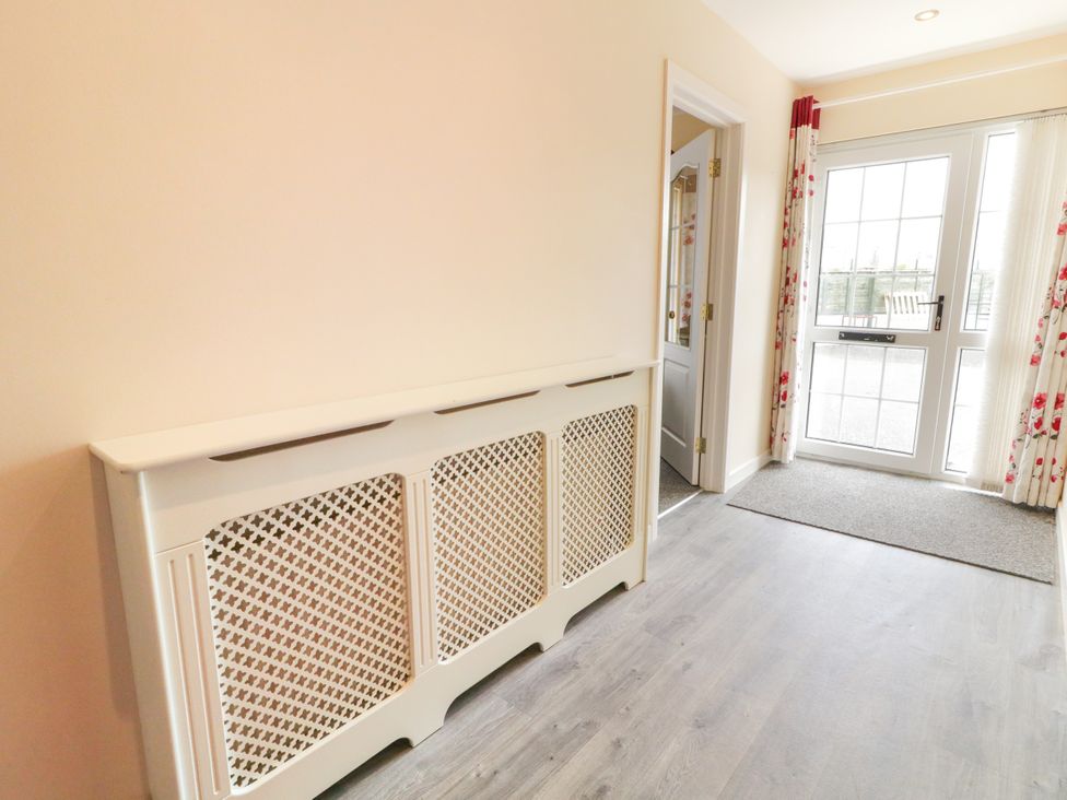 A hallway with a radiator cover and door at 3 Warke Place Castlerock