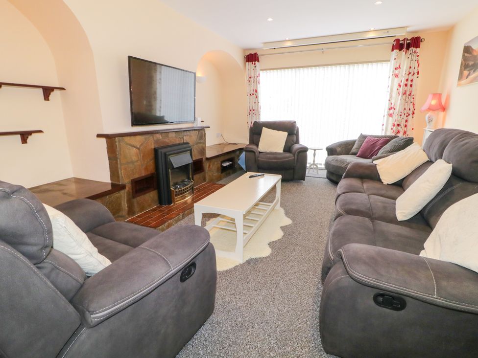 A living room with sofas and a television at 3 Warke Place Castlerock