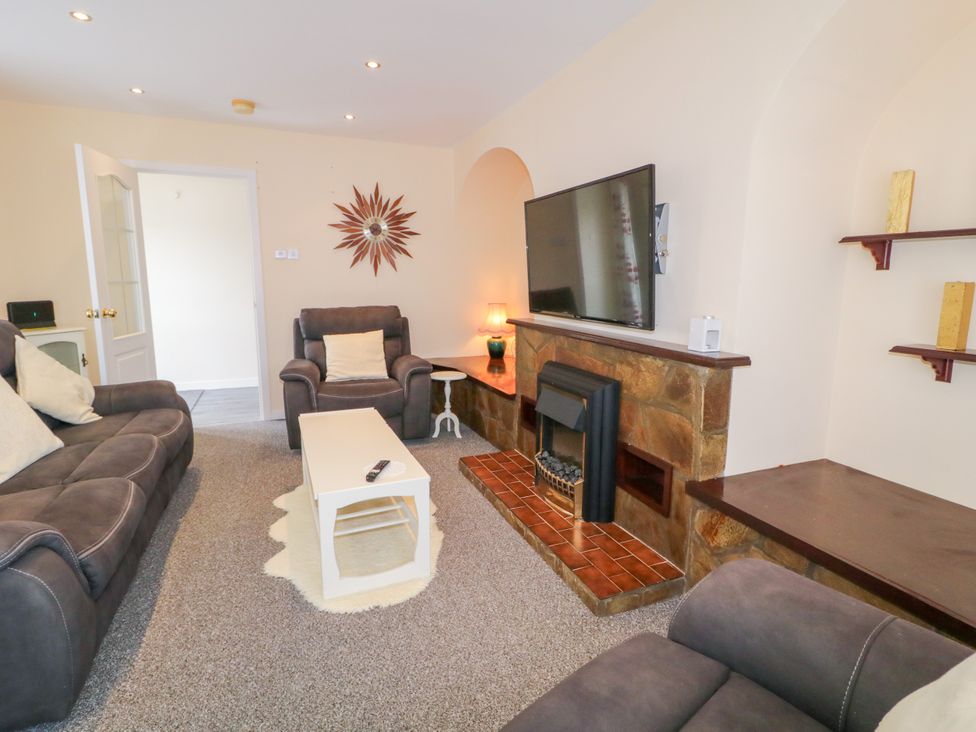 A living room with a sofa and television at 3 Warke Place in Castlerock