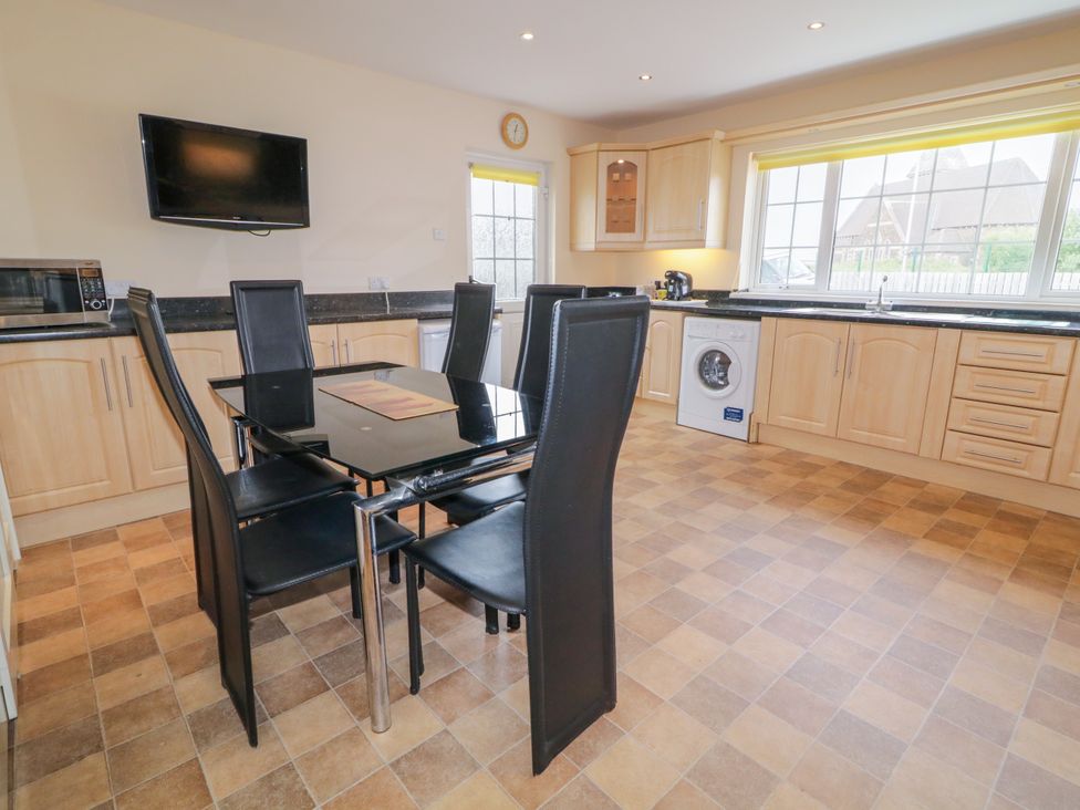 A kitchen with a dining table and chairs at 3 Warke Place Castlerock