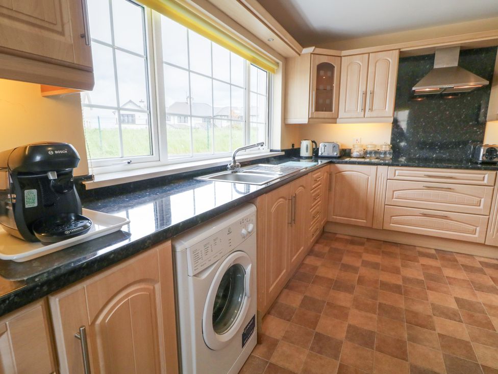 A kitchen with appliances and cabinets at 3 Warke Place Castlerock