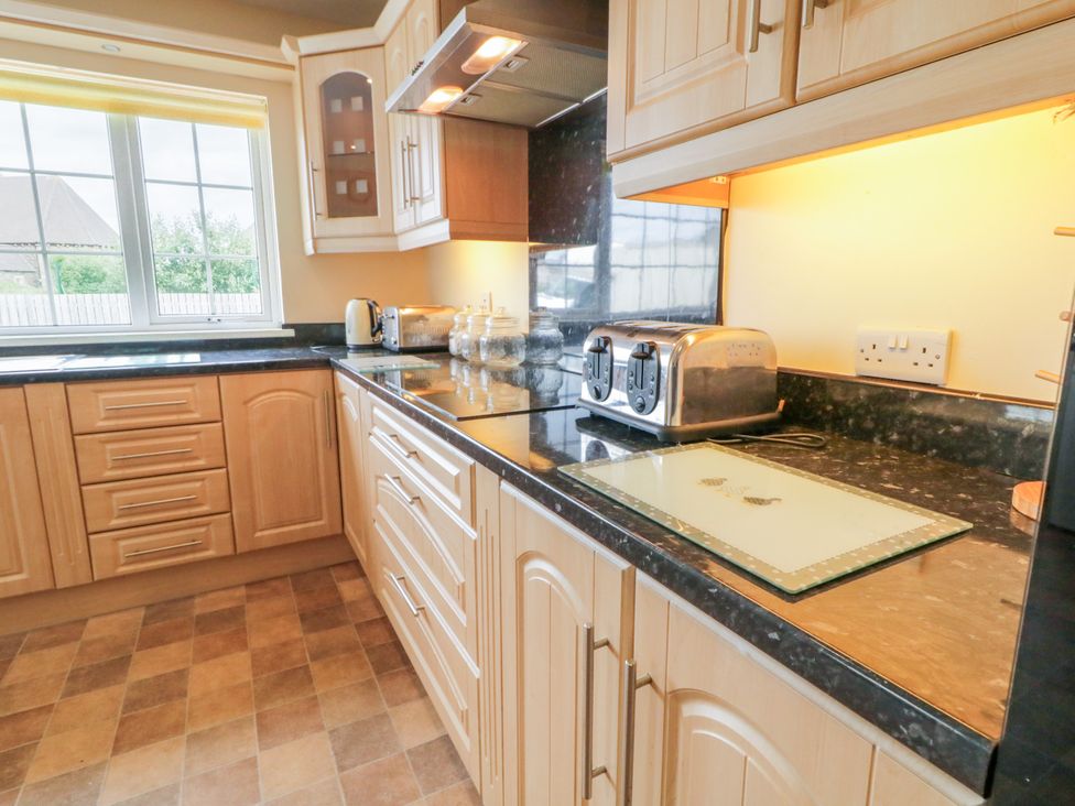 A kitchen with cabinets and appliances at 3 Warke Place in Castlerock