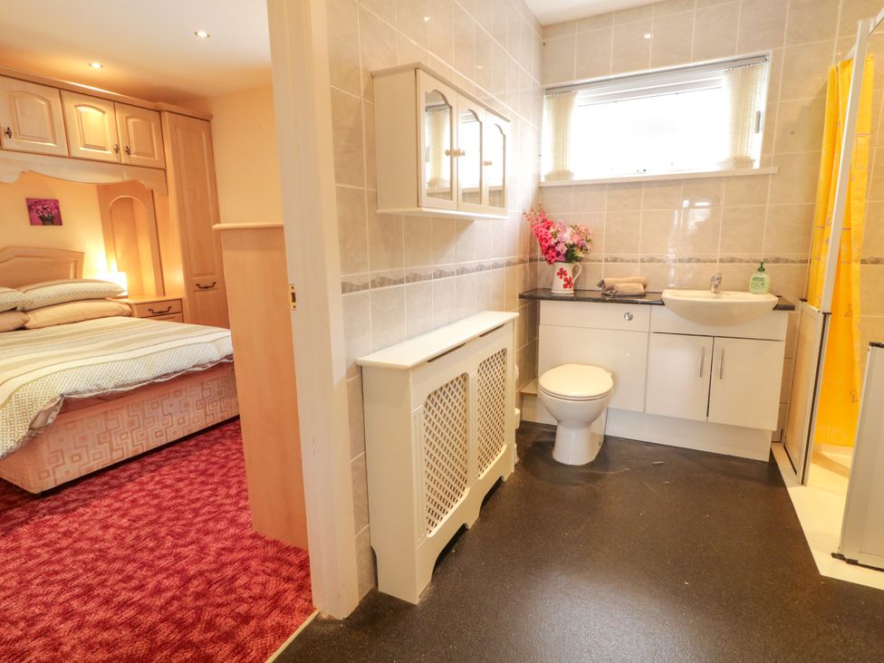 A bathroom with a sink, toilet, and shower at 3 Warke Place Castlerock