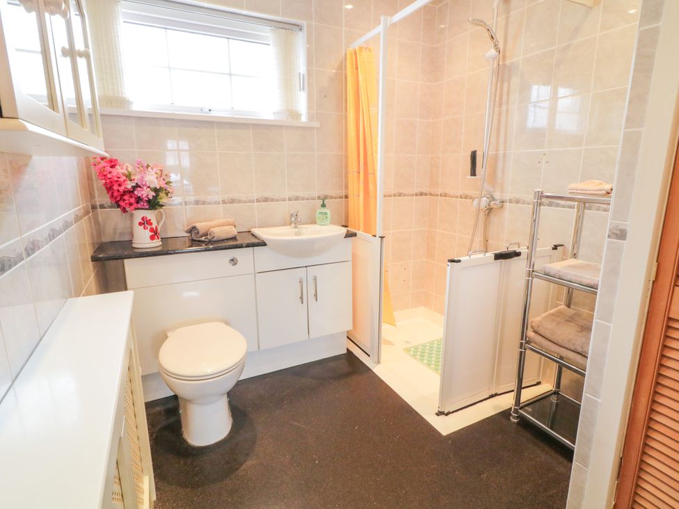 A bathroom with a shower, sink, and toilet at 3 Warke Place Castlerock