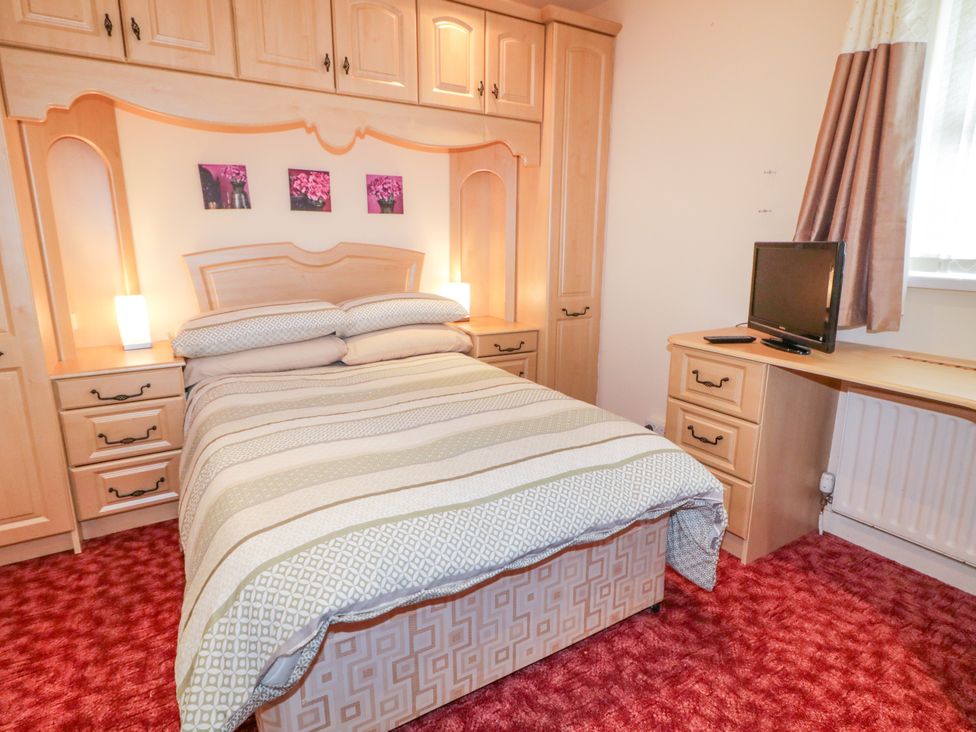 A bedroom with a bed and tv at 3 Warke Place Castlerock
