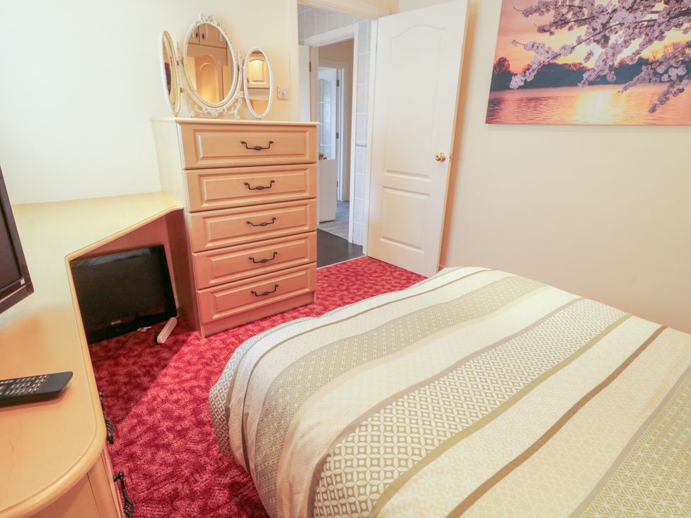 A bedroom with a bed and dresser at 3 Warke Place Castlerock