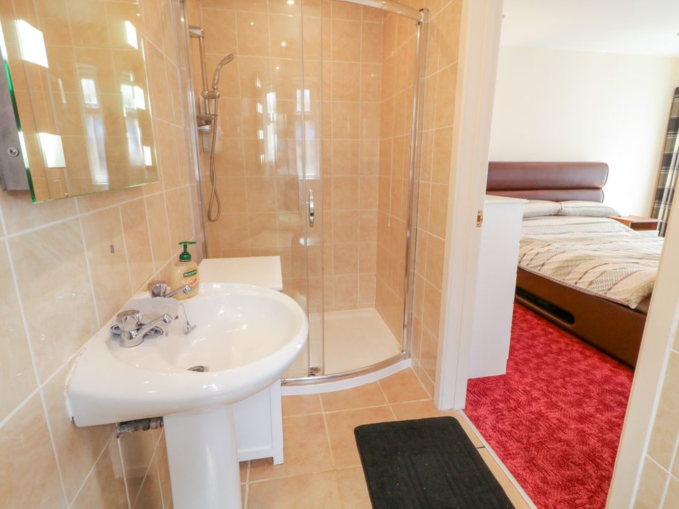 A bathroom with a shower and sink at 3 Warke Place Castlerock