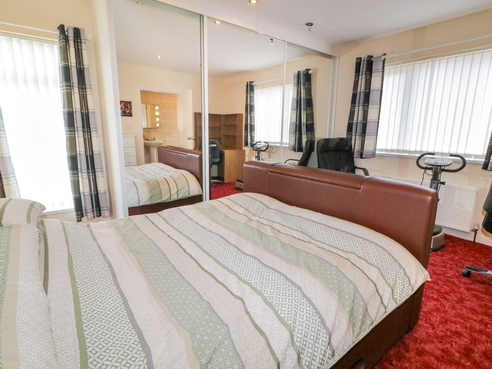 A bedroom with a bed and desk at 3 Warke Place, Castlerock