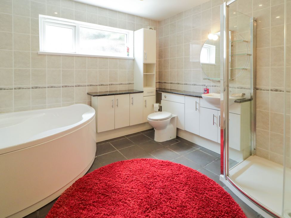 A bathroom with a bathtub, shower, toilet, and sink at 3 Warke Place Castlerock